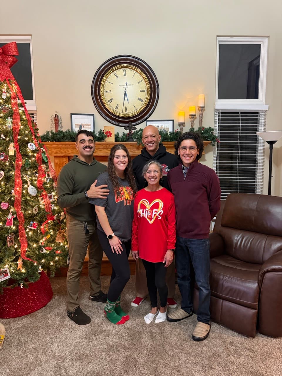 Garrett with his family by the Christmas tree